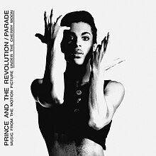 A black a white photo of a man with a black tank top and his arms posed in a theatrical way with the words PRINCE AND THE REVOLUTION/ PARADE