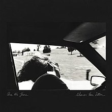 A black-and-white image of a seated woman in sunglasses looking out the open window of a moving car. Handwritten text underneath reads Are We There on the bottom left and Sharon Van Etten on the bottom right.