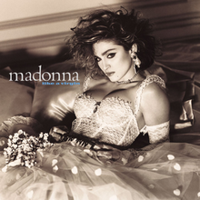 A sepia-toned image of Madonna in what looks like a wedding dress.